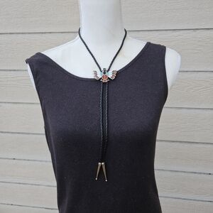 silver tone enamel thunderbird bolo tie on black leather cord